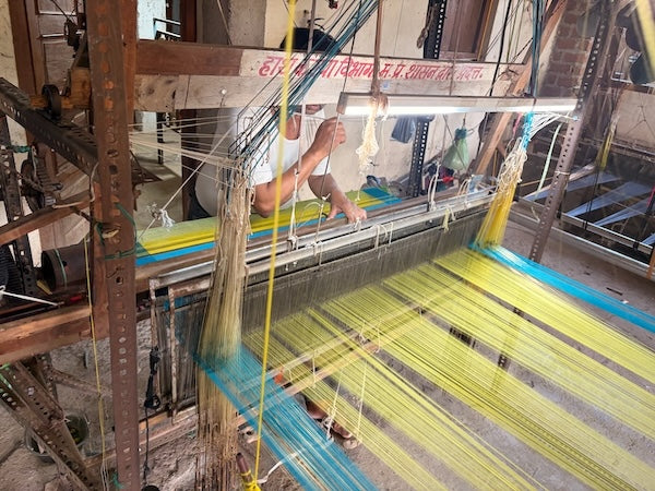 We don't drop 200 sarees a week. We drop 12 — and tell you who wove them.